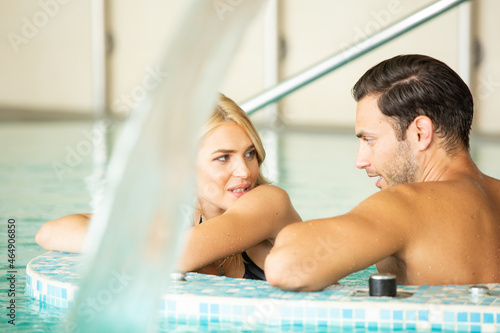 Attractive young couple relaxing in the indoor hotel swimming pool © rilueda