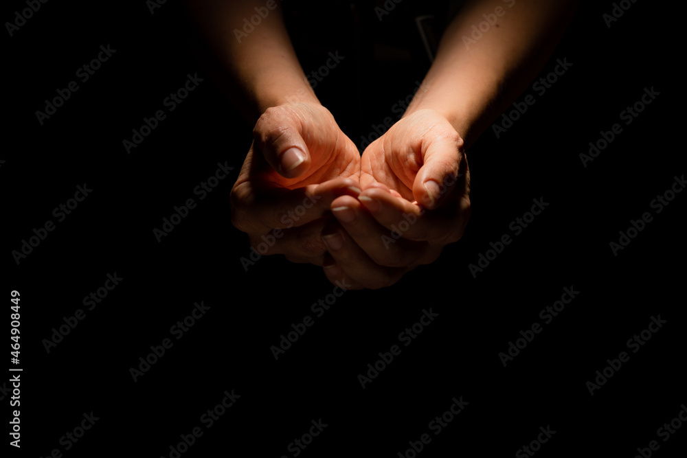 Begging, empty palms, outstretched hands. Concept of social disadvantage, black background. Begging, empty palms, outstretched hands. Concept of social disadvantage, black background.