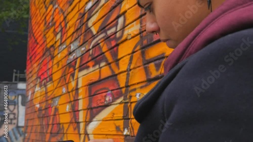 Young female analyzes a cryptocurrency stock market chart on her mobile phone