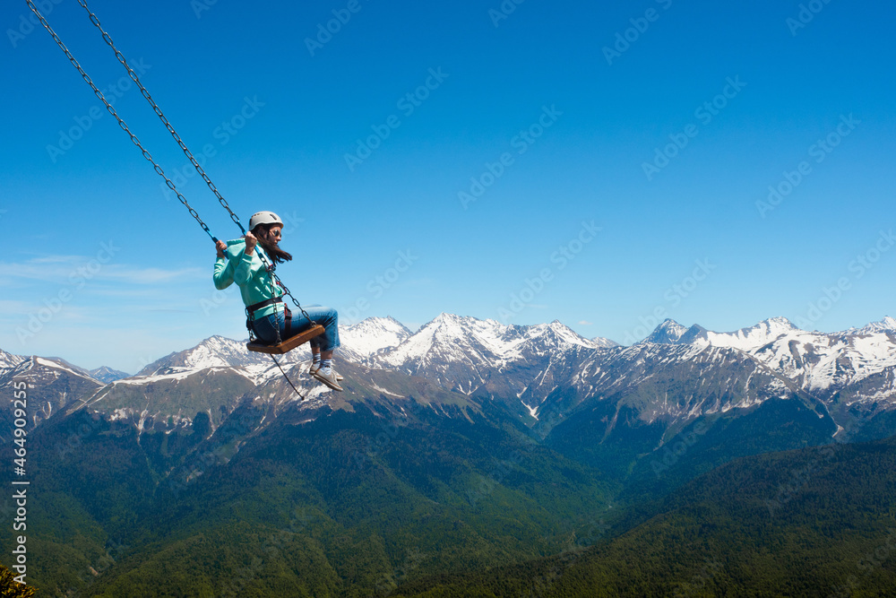 Flying on a mountain swing, entertainment in nature Flying on a mountain swing, entertainment in nature