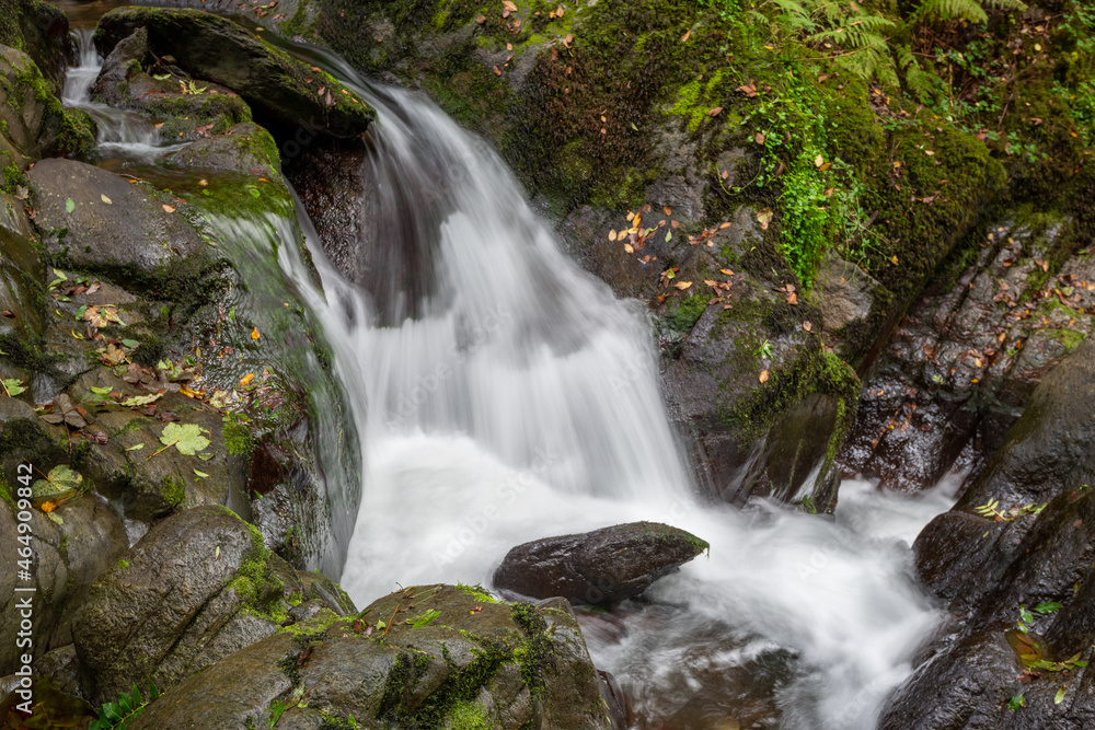 Long exposure of a waterfall on the Hoar Oak Water river at Watersmeet in Exmoor National Park