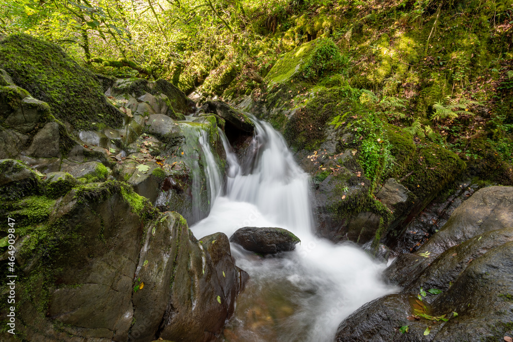 Long exposure of a waterfall on the Hoar Oak Water river at Watersmeet in Exmoor National Park Long exposure of a waterfall on the Hoar Oak Water river at Watersmeet in Exmoor National Park