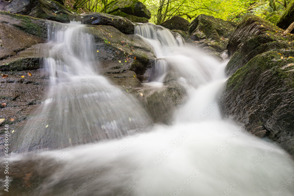 Long exposure of a waterfall on the Hoar Oak Water river at Watersmeet in Exmoor National Park Long exposure of a waterfall on the Hoar Oak Water river at Watersmeet in Exmoor National Park