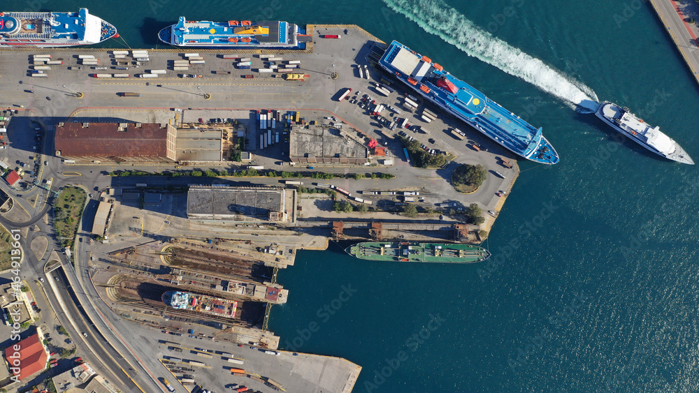 Aerial drone photo of famous and busy port of Piraeus where passenger ferries travel to Aegean destination islands as seen from high altitude , Attica, Greece