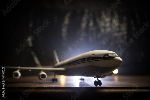 Artwork decoration. White passenger plane ready to taking off from airport runway. Silhouette of Aircraft during night time.