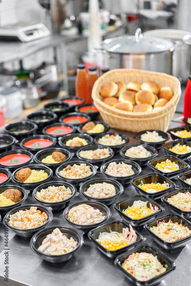 Food delivery. Different in plastic disposable lunch box with healthy natural food. Chicken broth, mashed soup, mashed potatoes with cutlet, seafood pasta, salads, pilaf with a fresh bun. Food delivery. Different in plastic disposable lunch box with healthy natural food. Chicken broth, mashed soup, mashed potatoes with cutlet, seafood pasta, salads, pilaf with a fresh bun.
