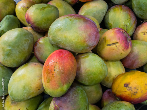 Fruits and vegetables background. Healthy Living: Elevate Your Well-being with Nutritious Habits! Close-up of mangos in a supermarket.