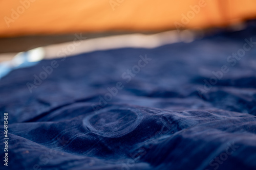 Slika na platnu Selective focus of an inflatable air mattress on the floor of a tent being filled up