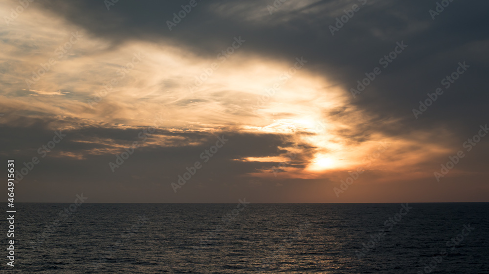 Sunlight breaks through storm clouds over the Mediterranean. 