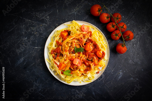noodles, tomato on concrete background