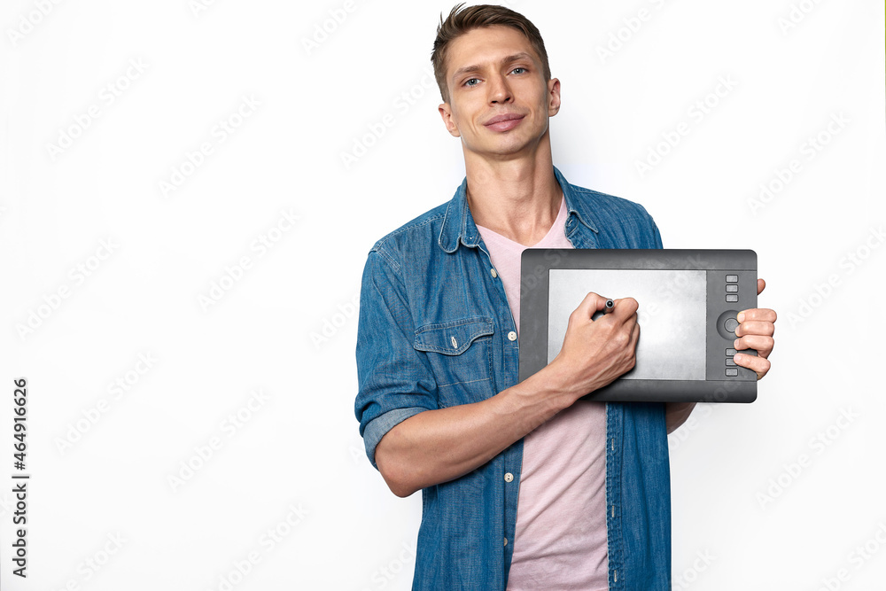 A male designer in casual style holding graphic tablet A male designer in casual style holding graphic tablet