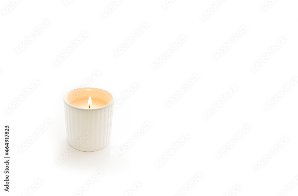 Close-up of a candle on a white background with copy space right side. Close-up of a candle on a white background with copy space right side.