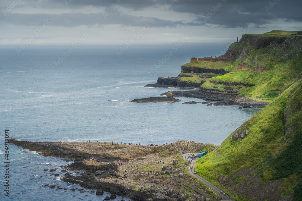 Crowds of tourists visiting Giants Causeway, seen from top of the cliff, Wild Atlantic Way and UNESCO world heritage, located in Northern Ireland