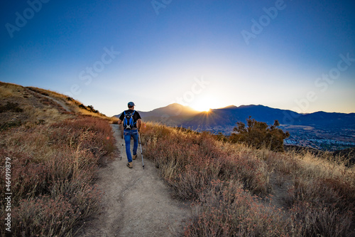 hiker in the mountains at sunrise