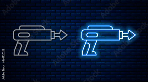 Glowing neon line Fishing harpoon icon isolated on brick wall background. Fishery manufacturers for catching fish under water. Diving underwater equipment. Vector