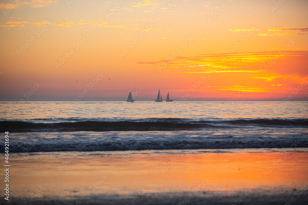 Sunset in the sea with beautiful clouds. Sunrise ocean seascape.