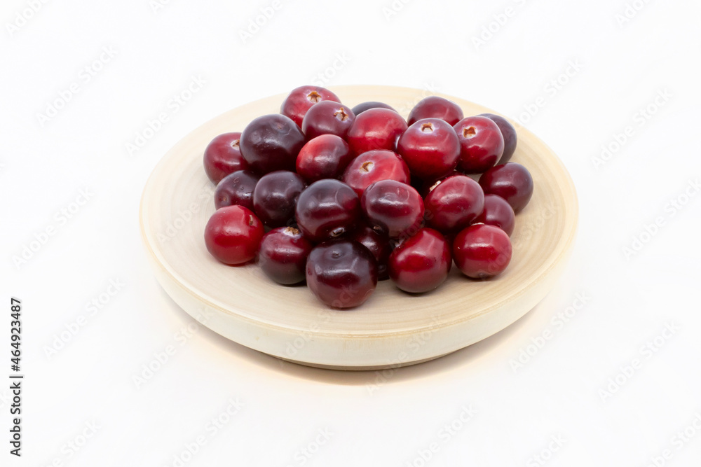 Cranberries on a plate isolate on a white background Cranberries on a plate isolate on a white background