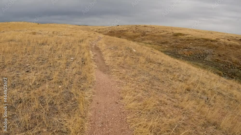 First person POV from riding a mountain bike on a single track trail on Colorado prairie, late October scenery in Soapstone Prairie Natural Area First person POV from riding a mountain bike on a single track trail on Colorado prairie, late October scenery in Soapstone Prairie Natural Area