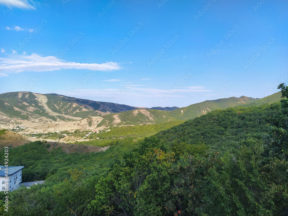 Mountain landscape with green summer forests. Green moutain forests landscape. Caucasus mountains.