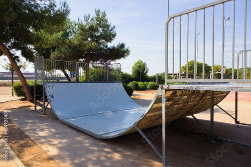 Side view of an outdoor public skatepark ramp