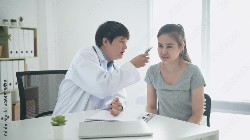 Medical concept of 4k Resolution. The doctor is measuring the temperature in the hospital room. Medical concept of 4k Resolution. The doctor is measuring the temperature in the hospital room.