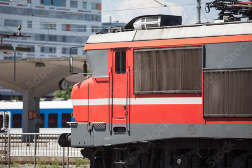 Red electric locomotive of Slovenian Railways shunting on Ljubljana train station platform getting ready for departure. it is the main hub of slovenian railroad... photo