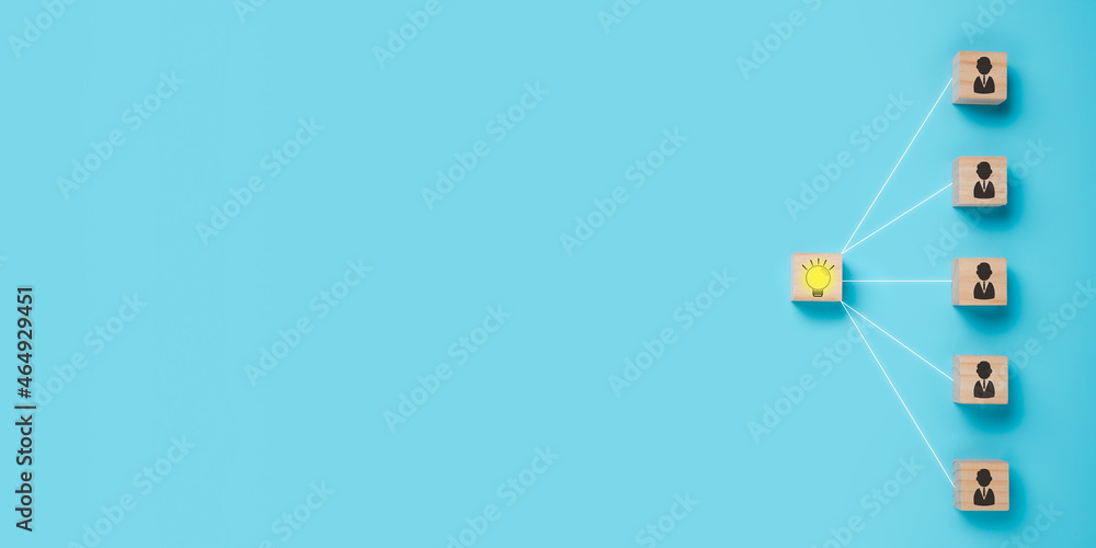 Fototapeta premium Wooden cube block with head human symbol and light bulb icon on blue background, copy space, Concept creative idea and innovation, idea, teamwork.