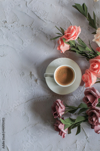 Coffee cup with rose flower on white table background. Valentine day with place for text. Vintage photo. Space for text