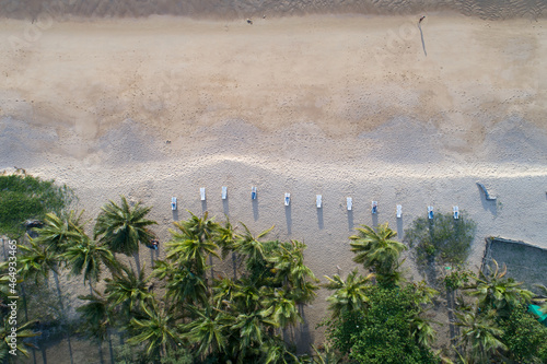 Aerial view top view of Coconut palm trees on the beautiful Karon beach Phuket Thailand Amazing sea beach sand tourist travel destination in the andaman sea Beautiful phuket island in sunset time
