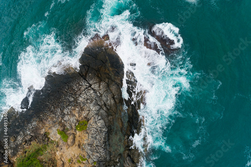 Aerial view of sea crashing waves White foaming waves on seashore rocks Top view fantastic Rocky coast Amazing nature background