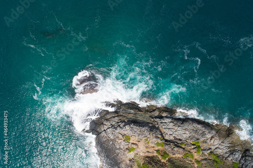 Aerial view of sea crashing waves White foaming waves on seashore rocks Top view Rocky coast