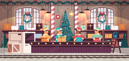 mix race elves team putting gifts on machinery line conveyor belt happy new year christmas holidays celebration