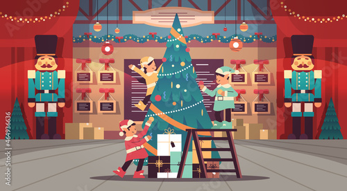 elves in uniform santa helpers team decorating fir tree happy new year merry christmas holidays celebration
