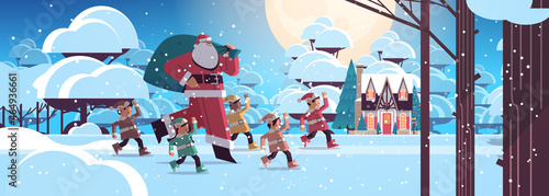 santa claus with mix race elves in night snowy forest happy new year merry christmas holidays celebration concept