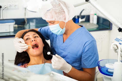 Male dentist with female patient during oral checkup in dentistry
