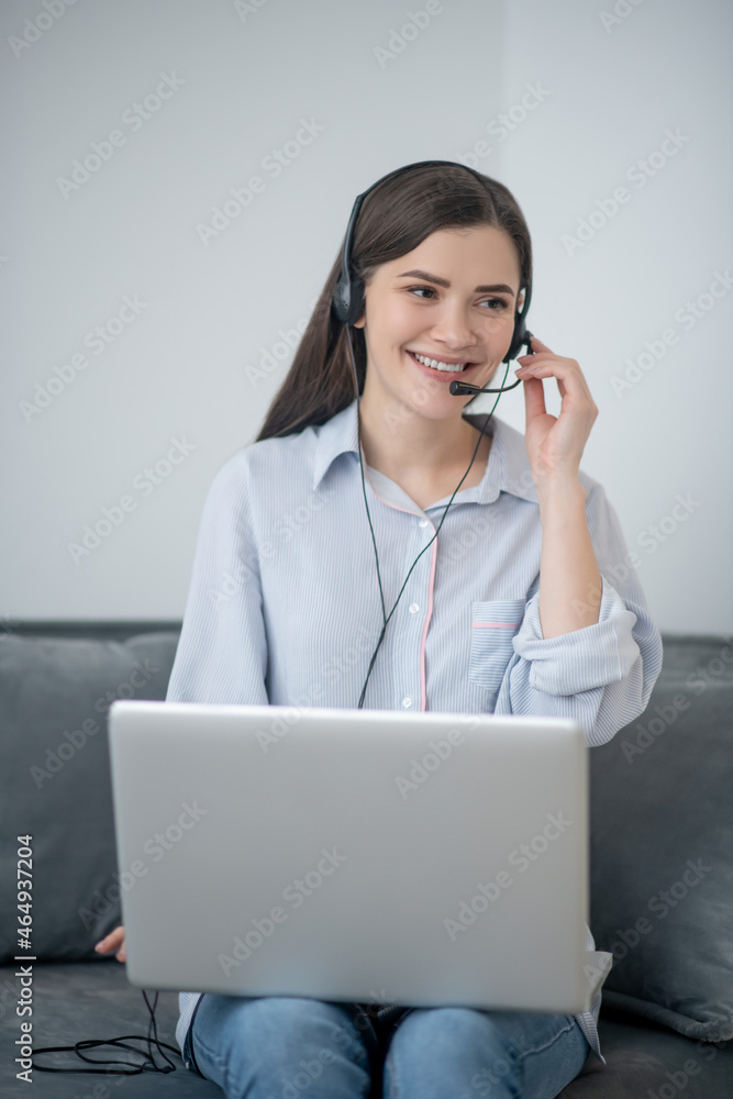 A pretty dark-haired operator of call canter working from home A pretty dark-haired operator of call canter working from home