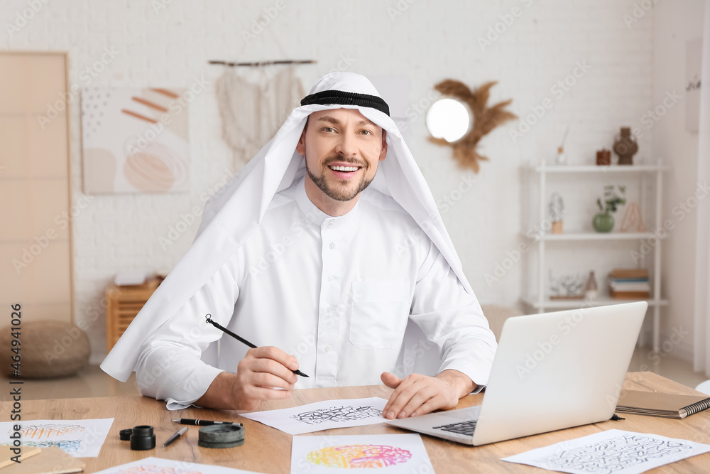 Male Arab calligraphist working in office Male Arab calligraphist working in office