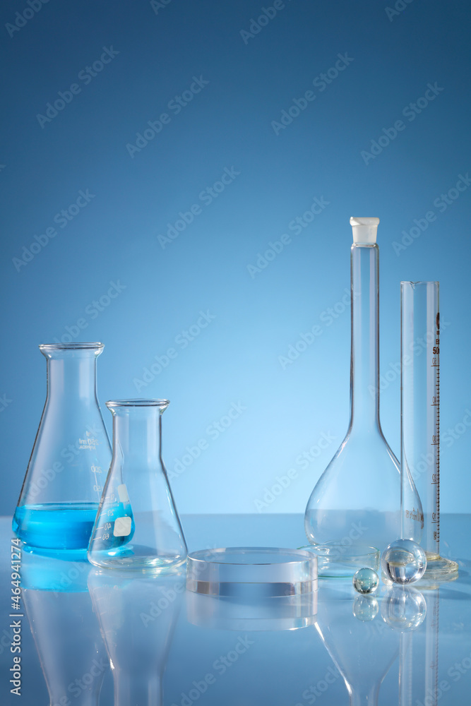 Front view of scientist working with chemical reaction in chemistry laboratory. . Blue liquid in transparent test tube and blue blackground with blank space for advertising Front view of scientist working with chemical reaction in chemistry laboratory. . Blue liquid in transparent test tube and blue blackground with blank space for advertising