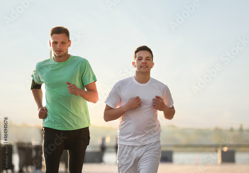 Sporty young men running outdoors
