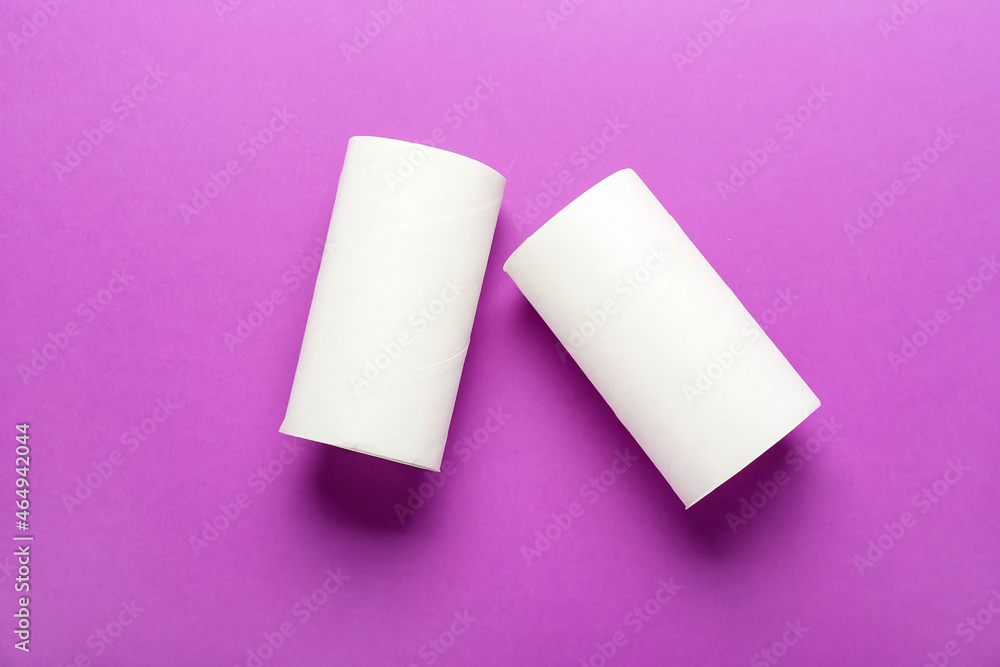 Empty toilet paper tubes on purple background Empty toilet paper tubes on purple background