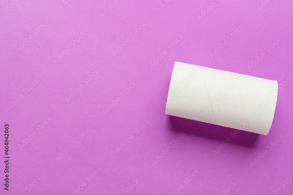 Empty toilet paper tube on purple background Empty toilet paper tube on purple background