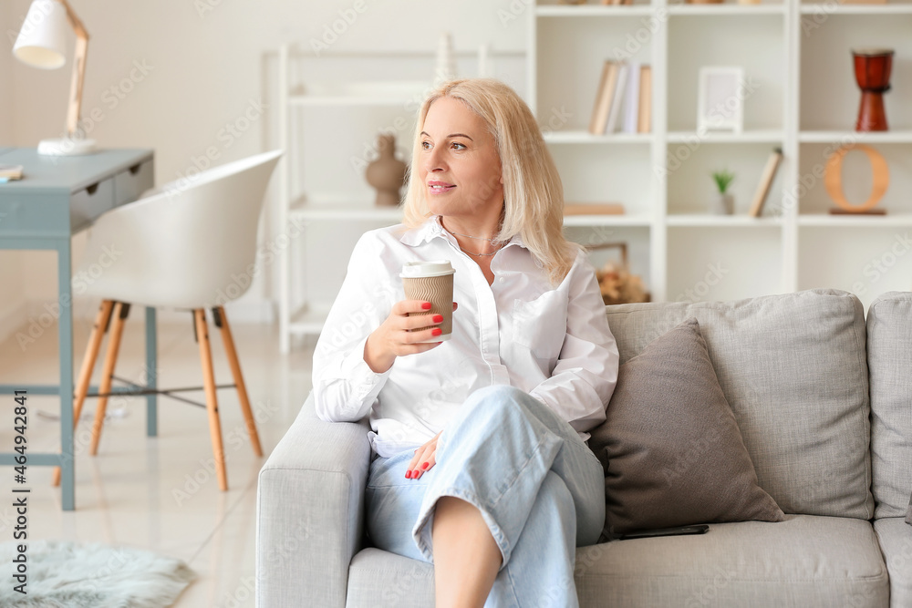 Beautiful mature woman with cup of coffee at home Beautiful mature woman with cup of coffee at home