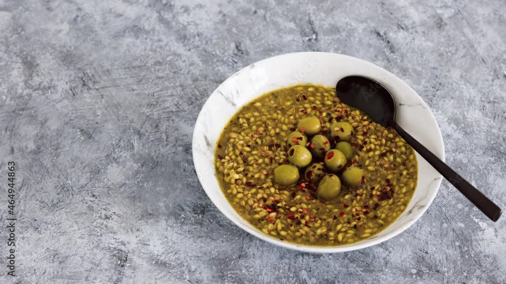 vegan spicy barley with olives and chilli flkes topping, healthy plant-based food