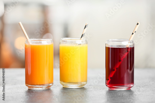 Glasses with healthy juice on table in room
