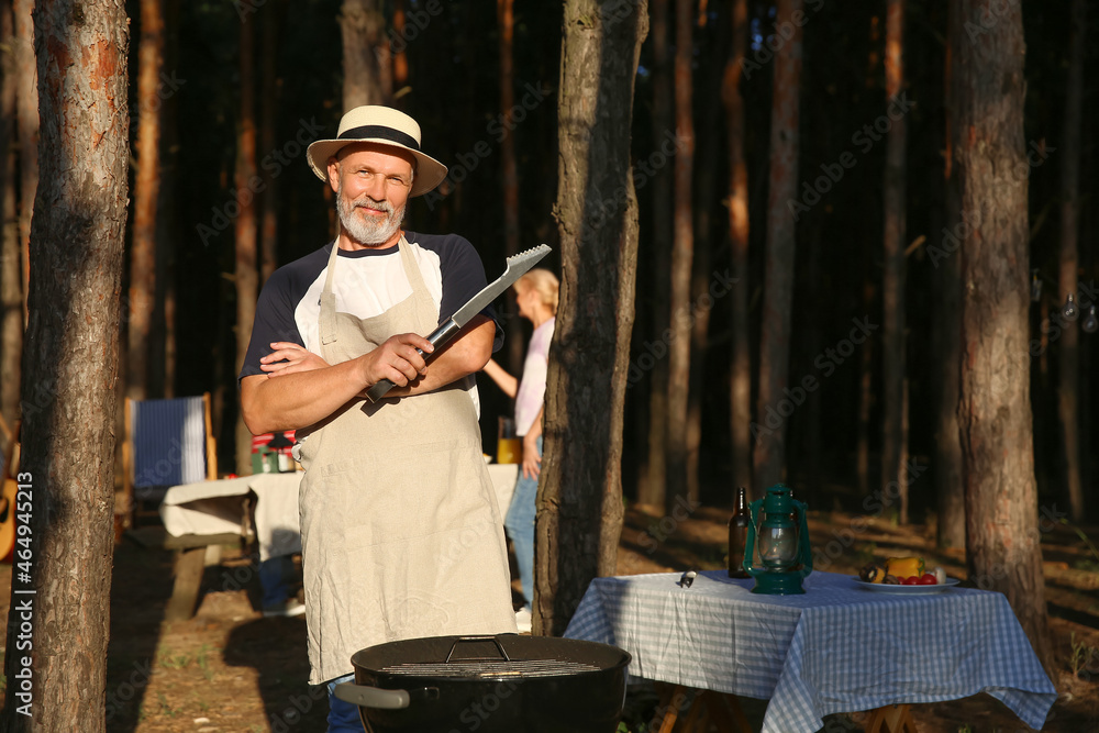 Mature man at barbecue party on summer day