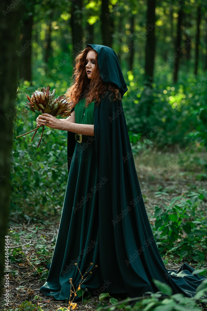 Naklejka premium Young witch in green forest