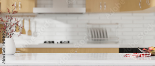 Kitchen island countertop on blurred modern white and wooden kitchen interior. photo