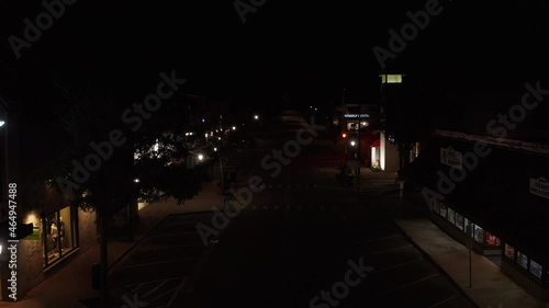 Drone flying over Joliet Prison in Naperville at night, Illinois. Drone moving backward over a empty street at night. photo