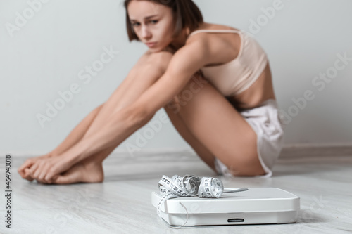 Young woman with scales and...
