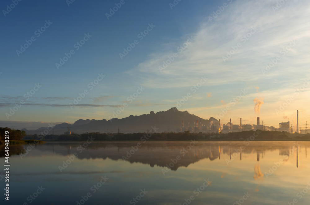 Coal power plant and water reflection in the morning among the mountains and lakes. Mae Moh, Lampang, Thailand. Coal power plant and water reflection in the morning among the mountains and lakes. Mae Moh, Lampang, Thailand.